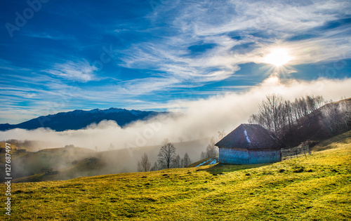 Rural landscape with fog in Sirnea – Fundata village, Transylvania landmark, Romania photo