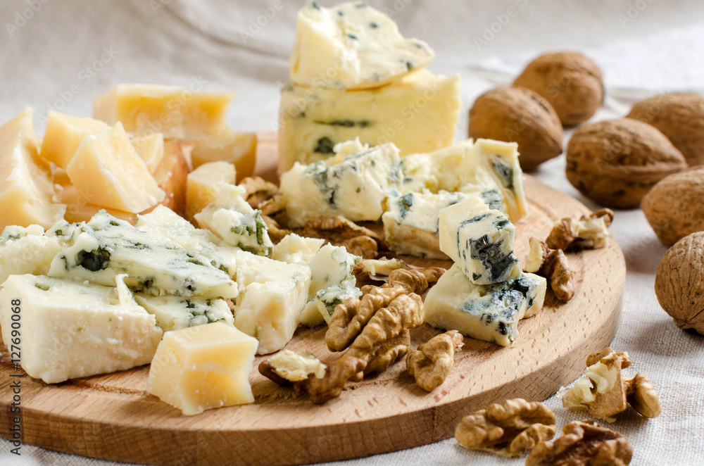 Assorted cheeses on wooden Board