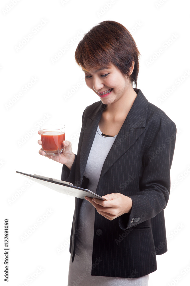 Asian business woman with clipboard and tomato juice. Asian business woman with clipboard and tomato juice.