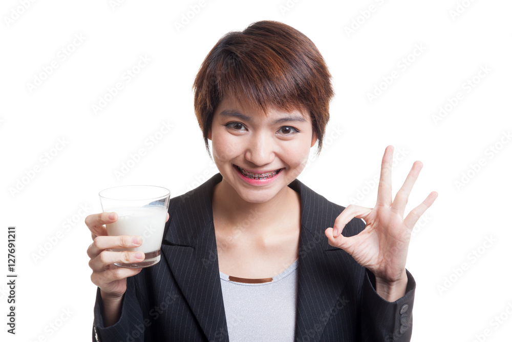 Healthy Asian woman drinking a glass of milk show OK sign. Healthy Asian woman drinking a glass of milk show OK sign.