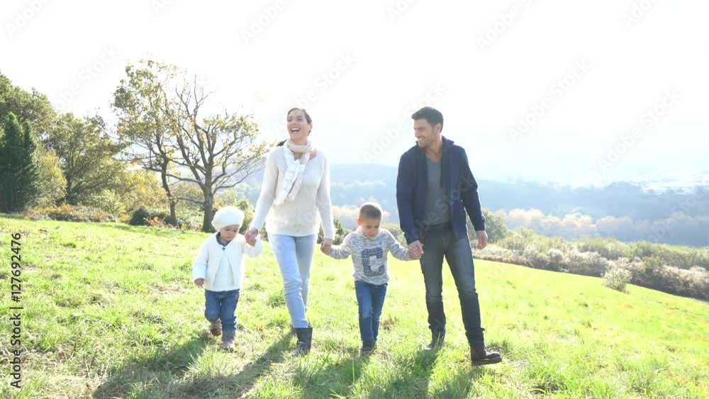 Happy family running in countryside on autumnal week-end Happy family running in countryside on autumnal week-end
