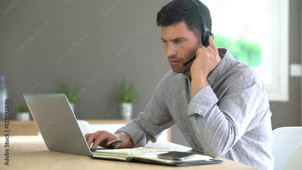 Sales representative working from home on laptop computer Sales representative working from home on laptop computer