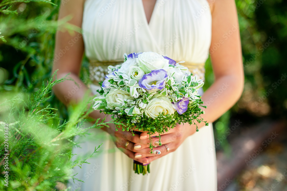 Wedding bouquet in the hands of the bride Wedding bouquet in the hands of the bride