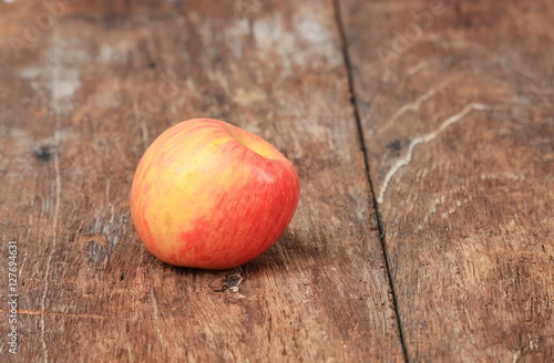 Red Apple on wooden background,  with copy space. © pramot48