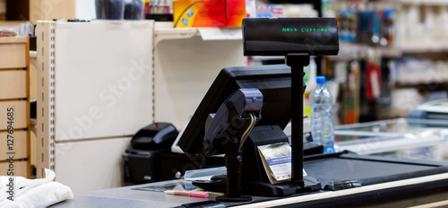 Empty cash desk with terminal in supermarket