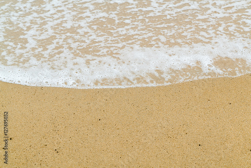 Soft wave on sand beach. Selective focus