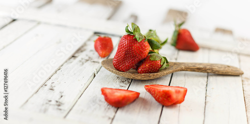 Fresh strawberry on white wood background