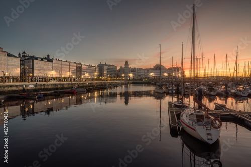 view of touristic sea sport harbor with modernist architecture buildings at down in A Coruña capital, Galicia, Spain. Relaxing leisure touristic popular must see destination place in Corunna. photo