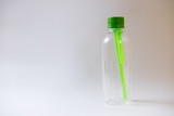plastic bottle of water green straws inside