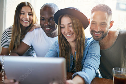 Woman holding tablet and showing to friends