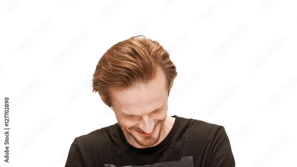 Young handsome man laughing, smiling over white background. Slow motion. Young handsome man laughing, smiling over white background. Slow motion.