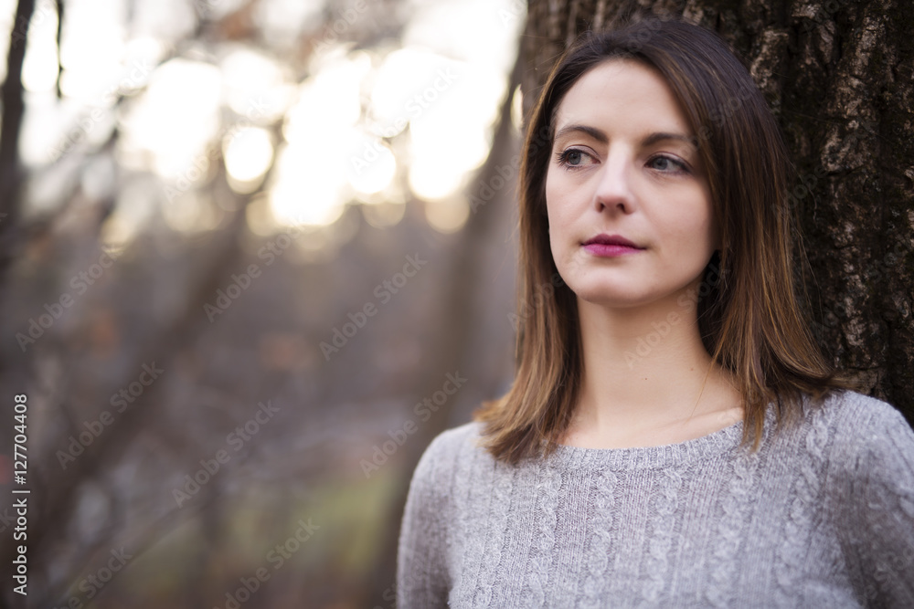 Woman with long hair in forest in autumn season Woman with long hair in forest in autumn season
