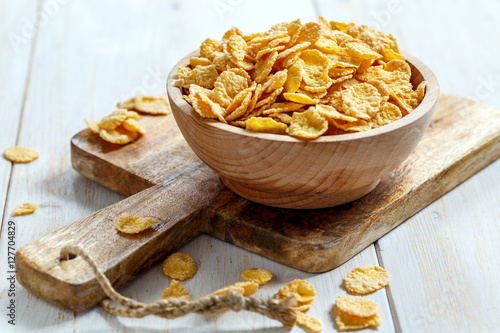 Corn flakes in a wooden bowl. photo