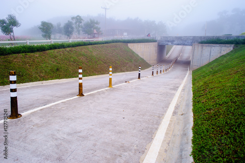 two way concrete street with traffic tube to cross road underpass.