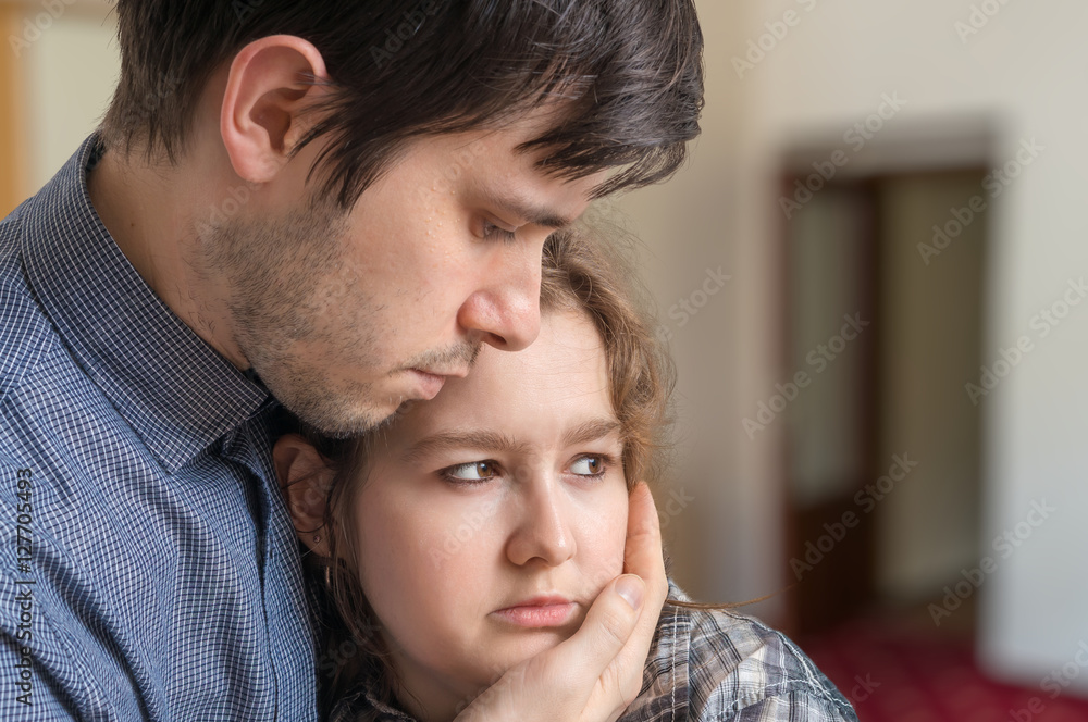 Young man is supporting his girlfriend and is hugging her. Young man is supporting his girlfriend and is hugging her.