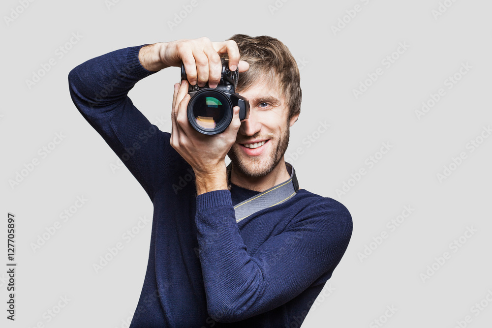 Young man photographer takes images with dslr camera Young man photographer takes images with dslr camera