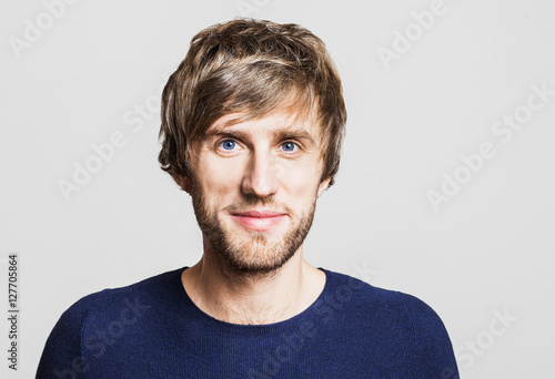 Cheerful smiling young man studio portrait photo