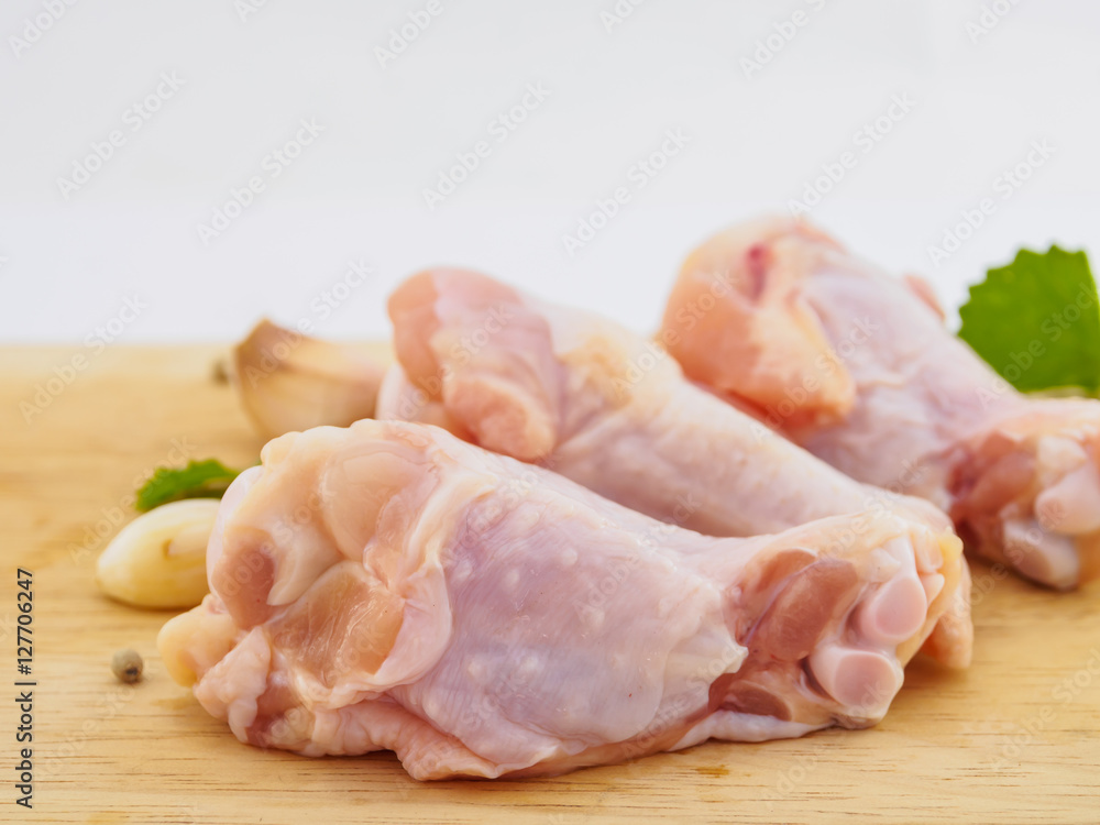 Fresh chicken drumstick group  on wood plate