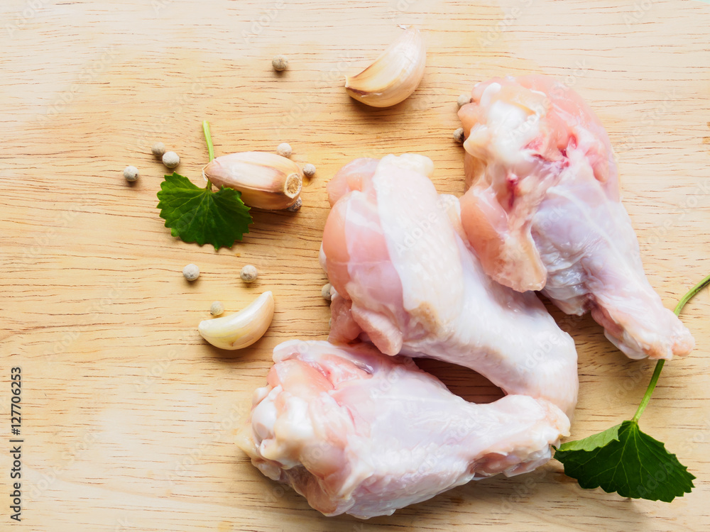 Top view chicken drumstick with ingredient on wooden background Top view chicken drumstick with ingredient on wooden background