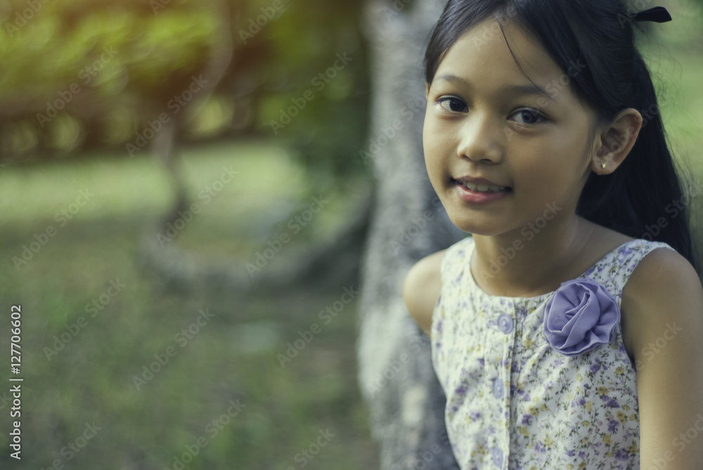 Little asian girl smiling in the park, close up. Little asian girl smiling in the park, close up.