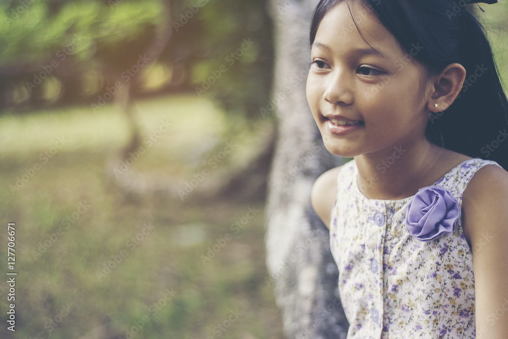 Little asian girl smiling in the park, close up. Little asian girl smiling in the park, close up.