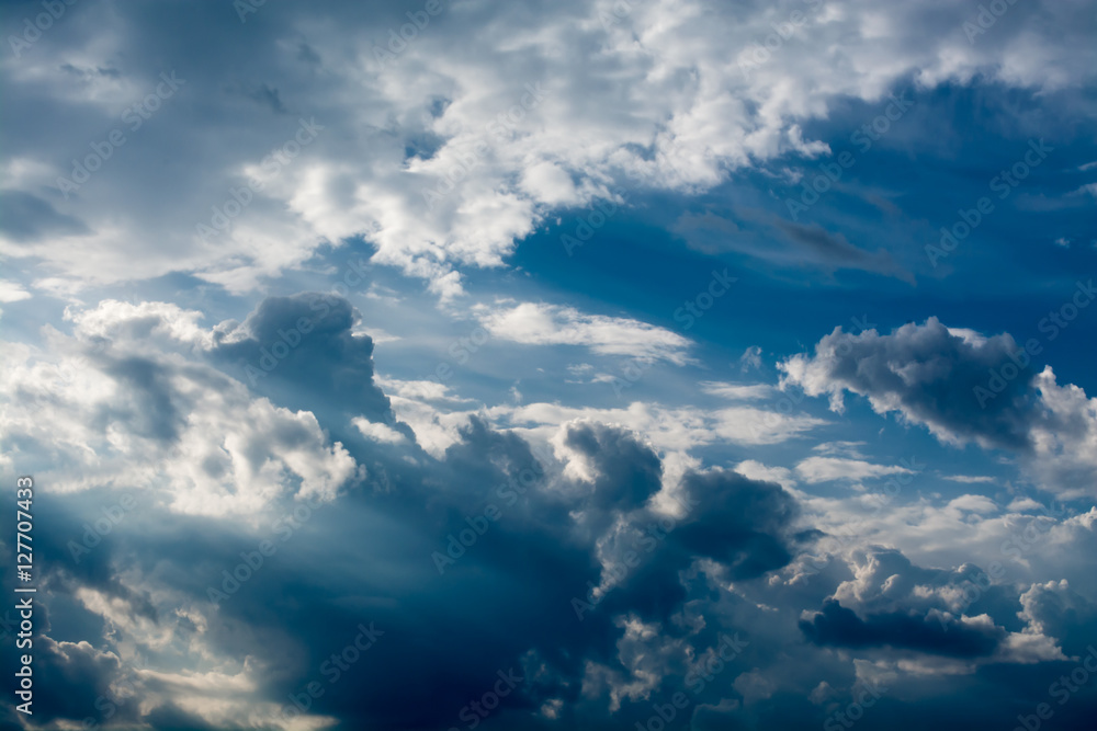 White curly clouds in a blue sky. Sky background White curly clouds in a blue sky. Sky background