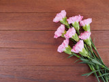Bouquet of sweet pink Carnation flower on wood background 1
