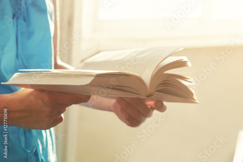hands holding book and reading