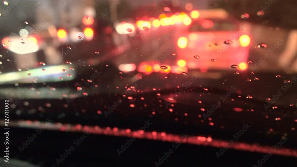 close up of water and watrer drop at front car window in traffic jam close up of water and watrer drop at front car window in traffic jam