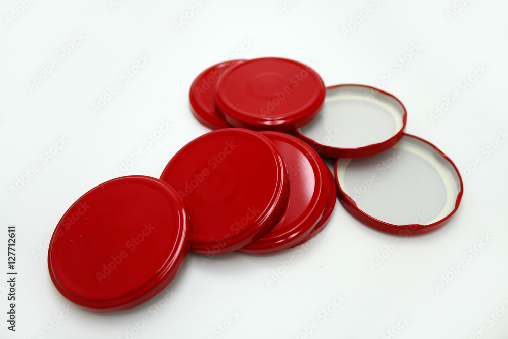 Red metal lids for canning on a white background Red metal lids for canning on a white background