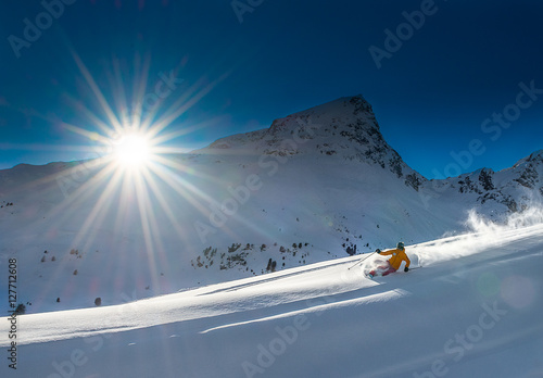 Fotografie Girl telemark skiing snow slope in mountains