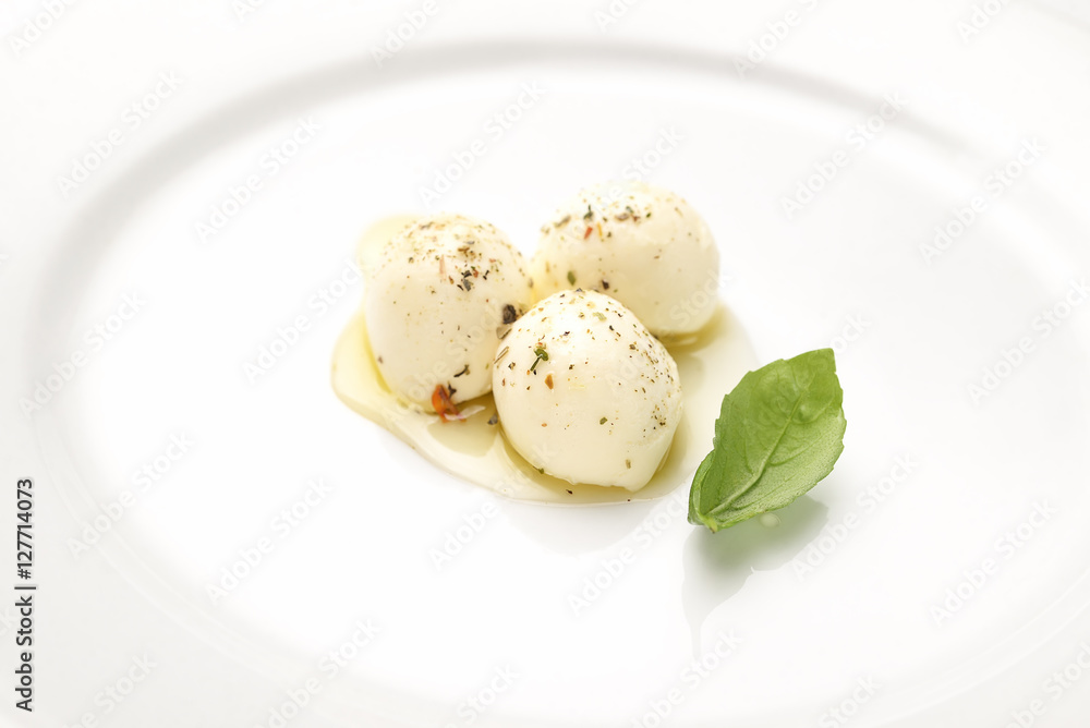 Top view of mozzarella cheese with cherry tomatoes and basil on a black slate surface Top view of mozzarella cheese with cherry tomatoes and basil on a black slate surface