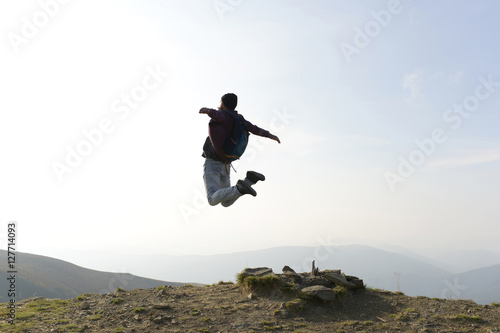 Man hipster jumps with backpack