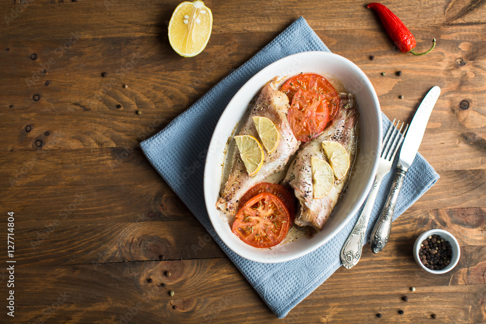 Baked sea bass with tomatoes and lemon
