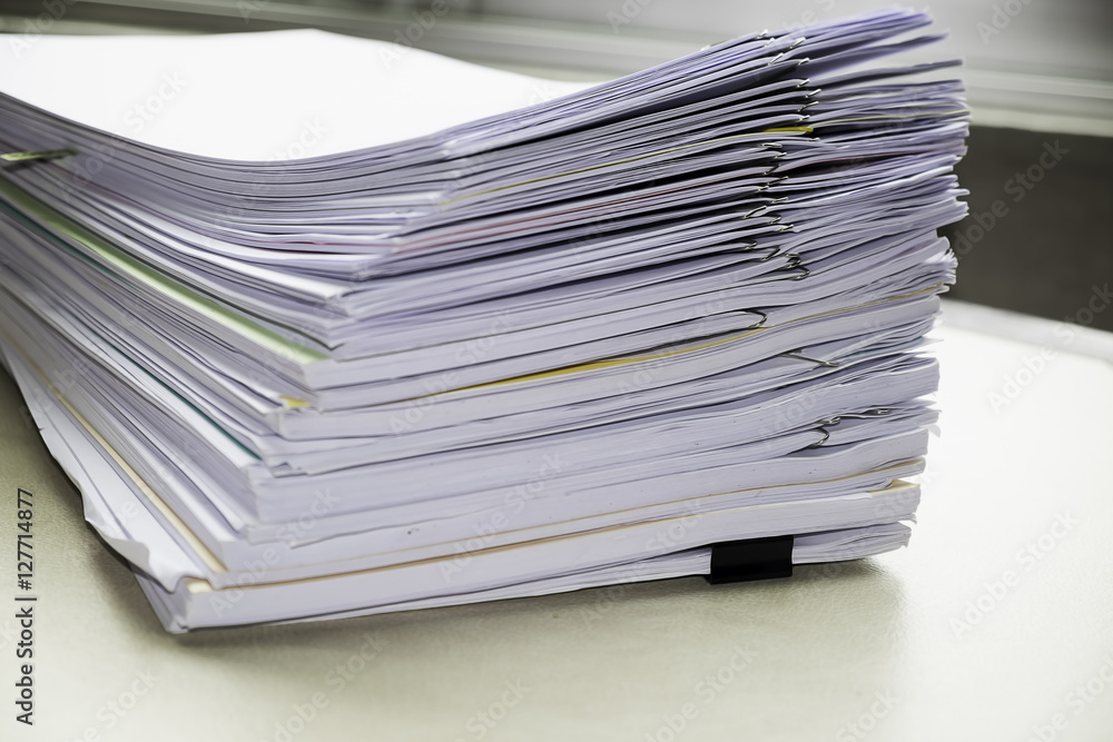 Pile of unfinished documents on office desk, Stack of business paper Pile of unfinished documents on office desk, Stack of business paper