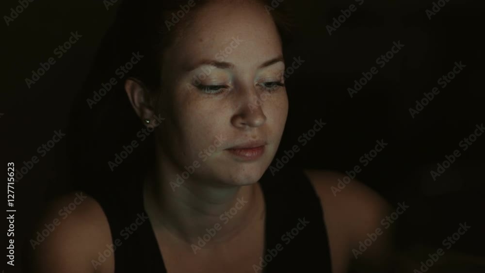 The girl looks at the screen