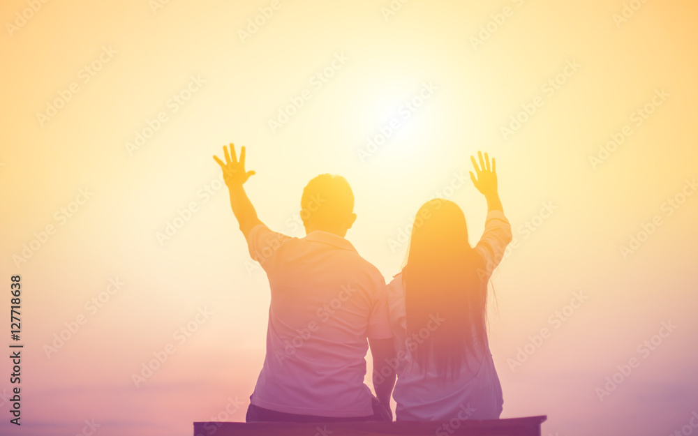 a silhouette of a man and woman holding hands with each other, w