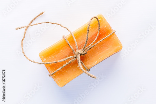 natural handmade soap with tied with rough rope on a white backg