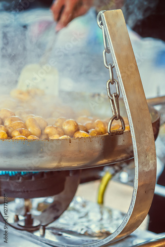 New potatoes fried in a pan with Italian recipe: potatoes salent photo