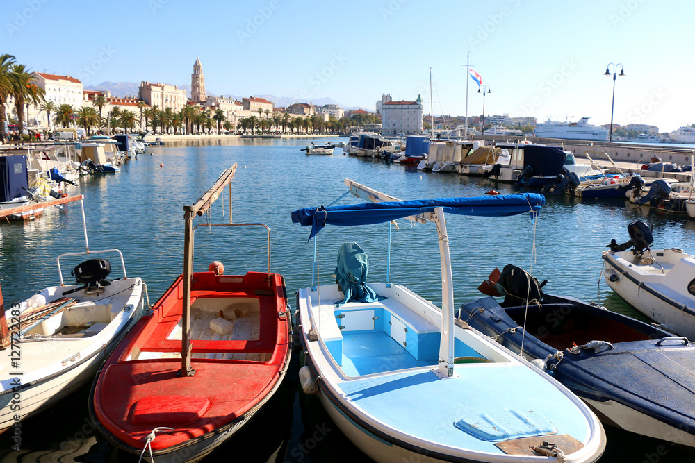 Small fishing boats in Matejuska cove in Split, Croatia. Riva promenade with Saint Domnius bell tower in the background. 