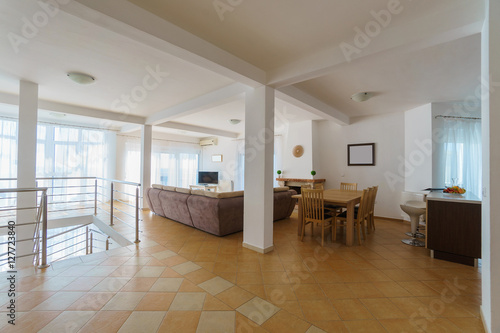 Interior of a living room with kitchen zone in a villa © wolfcub777