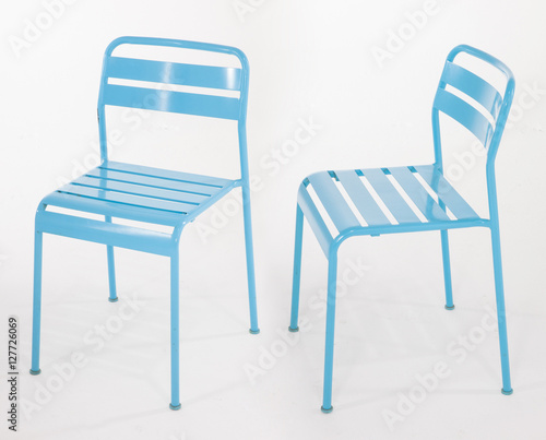 Turquoise metal chairs on white
