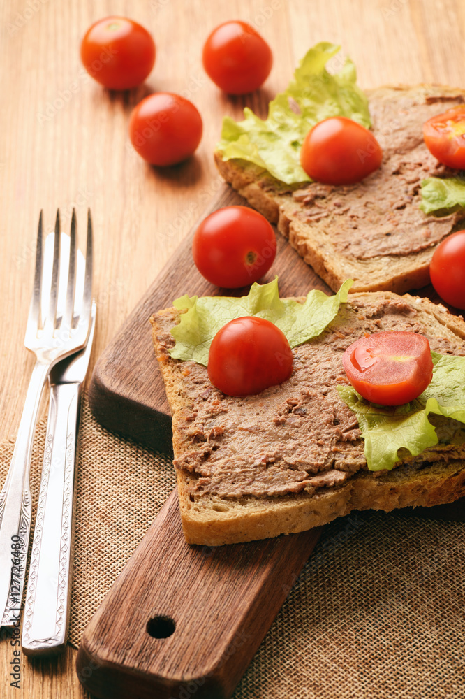 Chicken liver pate on the bread on wooden tray. Chicken liver pate on the bread on wooden tray.