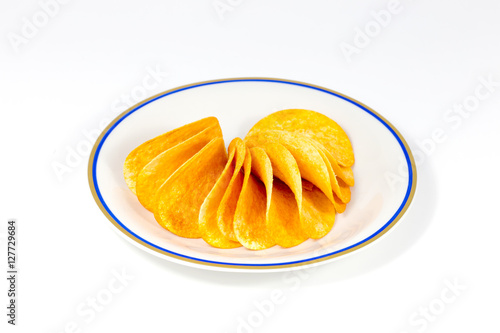 snack potatoes in plate on white background / ribbed potatoes snack with pepper isolated on white / Potato chips