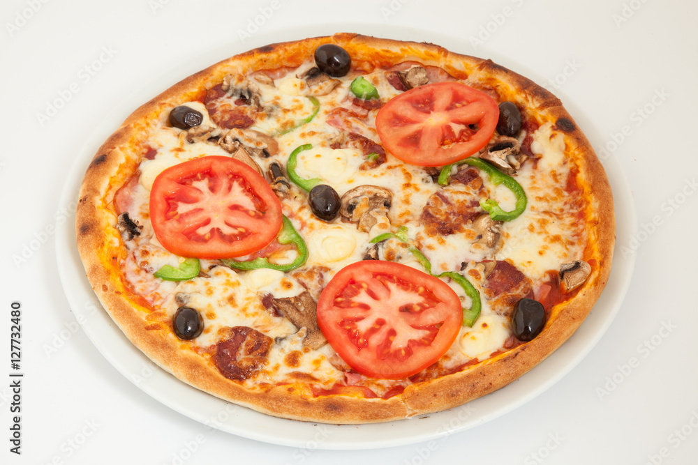 Delicious italian pizza with vegetables & cheese on white plate