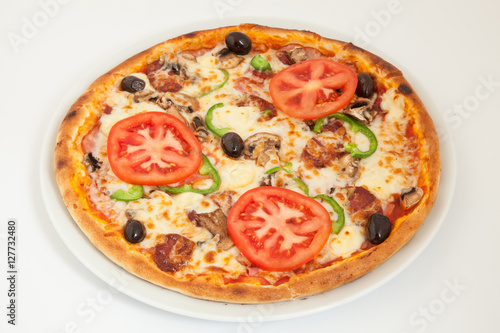 Delicious italian pizza with vegetables & cheese on white plate