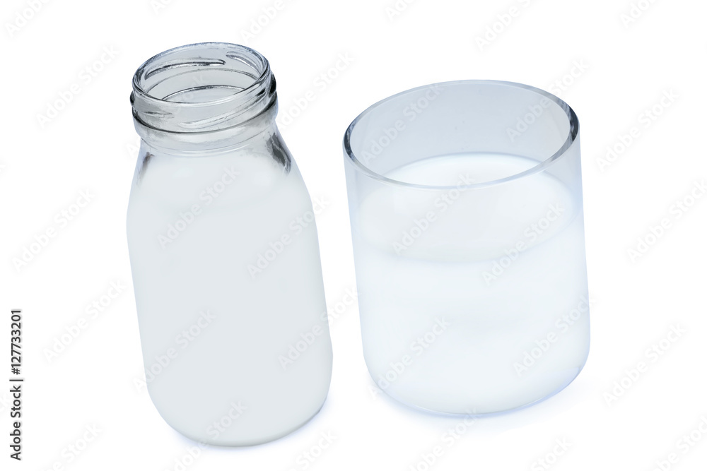 Milk in a bottle and glass on white background Milk in a bottle and glass on white background