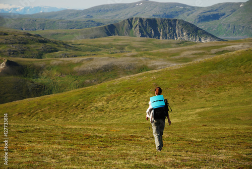 Woman hiking in green mountains of summer Soroya.