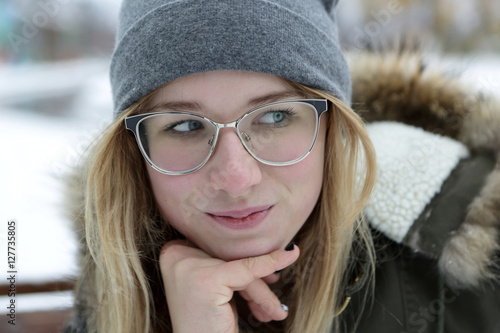 Smiling girl in glasses in winter