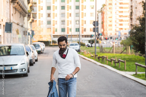 Indian man posing in an urban context.